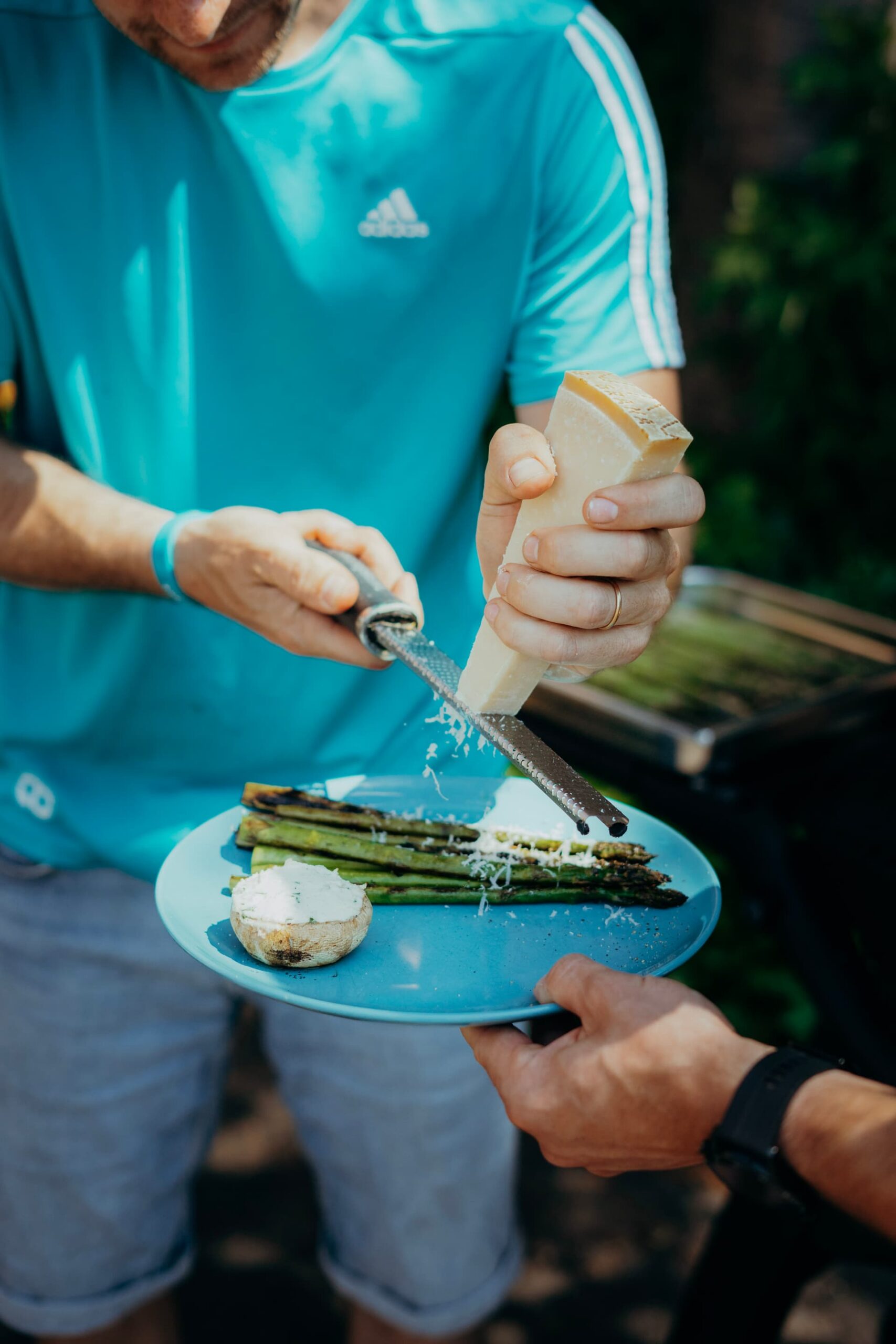 Gegrillter grüner Spargel serviert auf einem hellen Teller